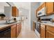 Functional kitchen with wooden cabinets, appliances, and a view into a dining area at 101 Danzid Dr, Summerville, SC 29483