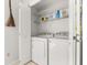 Functional laundry area featuring a washer, dryer, and storage shelves behind a bi-fold door at 101 Danzid Dr, Summerville, SC 29483