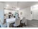 Dining area featuring modern white table and chairs, pendant lighting, and bright open floor plan at 1020 Drakeford St # 9P, Saint George, SC 29477