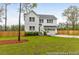 Charming two-story home with an attached two car garage, green lawn and a wood fence at 1020 Drakeford St # 9P, Saint George, SC 29477