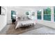 Inviting main bedroom features an area rug, a plush bed, and sun-drenched windows at 1020 Drakeford St # 9P, Saint George, SC 29477