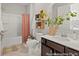 Bright bathroom with decorative plants, basket shelves, white tub, and stylish vanity at 1022 House Finch Ave # Cc3-22-10P, Ravenel, SC 29470