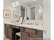 Spacious bathroom with dual sinks, dark wood cabinetry and a large mirror at 1022 House Finch Ave # Cc3-22-10P, Ravenel, SC 29470