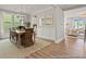 Open dining room with hardwood floors, modern lighting, table and chairs, with an adjacent living space at 1022 House Finch Ave # Cc3-22-10P, Ravenel, SC 29470