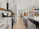 Bright kitchen featuring granite countertops, stainless steel appliances, backsplash, and modern fixtures at 1022 House Finch Ave # Cc3-22-10P, Ravenel, SC 29470