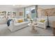 Inviting living room with white sofas, a stylish coffee table, and natural light from large windows at 1022 House Finch Ave # Cc3-22-10P, Ravenel, SC 29470