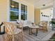 Relaxing front porch with comfortable seating, decorative rug, and stylish decor at 1022 House Finch Ave # Cc3-22-10P, Ravenel, SC 29470