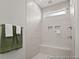 Modern walk-in shower with white tile, a built-in bench, and sleek fixtures at 1022 House Finch Ave # Cc3-22-10P, Ravenel, SC 29470