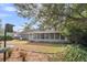 Spacious backyard with healthy landscaping and a large, screened porch along the rear of the house at 103 Night Hawk Ln, Summerville, SC 29485