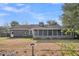 Expansive backyard with brick house, a screened porch, mature trees, and a bird bath at 103 Night Hawk Ln, Summerville, SC 29485