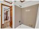 Bathroom showcasing a tiled shower/tub combination and a wooden door leading to another room at 103 Night Hawk Ln, Summerville, SC 29485