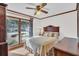 Cozy bedroom featuring a ceiling fan, wooden trim, and a large window providing natural light at 103 Night Hawk Ln, Summerville, SC 29485
