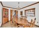 Traditional dining room featuring wooden furniture, a chandelier, with a built in cabinet for dinnerware and decorative plates at 103 Night Hawk Ln, Summerville, SC 29485