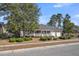 Charming brick home features an inviting front porch and an attached two-car garage at 103 Night Hawk Ln, Summerville, SC 29485