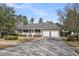 Charming brick home features an inviting front porch and an attached two-car garage at 103 Night Hawk Ln, Summerville, SC 29485
