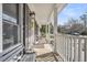 Inviting covered front porch with seating area to enjoy the outdoor scenery, plus classic black shutters and brick facade at 103 Night Hawk Ln, Summerville, SC 29485