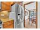 Stainless steel refrigerator nestled among custom cabinets, overlooking the dining room in this kitchen at 103 Night Hawk Ln, Summerville, SC 29485