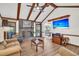Inviting living room featuring wood beams, a brick fireplace, and comfortable seating area at 103 Night Hawk Ln, Summerville, SC 29485