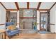 Charming living room featuring a brick fireplace, wood accents, and natural light at 103 Night Hawk Ln, Summerville, SC 29485