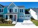 Charming two-story home with a covered front porch and an attached two-car garage at 1044 Northern Flicker Dr # Cc3-18-2P, Ravenel, SC 29470