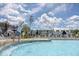 Enjoy the community pool with lifeguards, lounge chairs, and beautiful homes in the background at 1045 Northern Flicker Dr # Cc3-19-5P, Ravenel, SC 29470