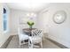 Cozy dining room with a round table, white chairs, chandelier, and natural light at 1045 Northern Flicker Dr # Cc3-19-5P, Ravenel, SC 29470