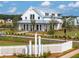 Stunning two-story white home with a metal roof, lush landscaping, and a charming white picket fence at 1045 Northern Flicker Dr # Cc3-19-5P, Ravenel, SC 29470