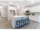 Modern kitchen with a large center island, white cabinets, and stylish bar stools for seating at 1045 Northern Flicker Dr # Cc3-19-5P, Ravenel, SC 29470
