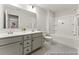 Bright bathroom with double sink vanity, large mirror, and combined shower/tub at 1047 House Finch Ave # Cc3-19-2P, Ravenel, SC 29470