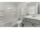 Bright bathroom featuring a tub with shower, a white vanity with storage and a decorative plant at 1047 House Finch Ave # Cc3-19-2P, Ravenel, SC 29470