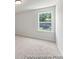 Minimalist bedroom with carpet, white walls, and window at 1047 House Finch Ave # Cc3-19-2P, Ravenel, SC 29470