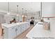 Modern kitchen featuring a large island, quartz countertops, stainless steel appliances, and pendant lighting at 1047 House Finch Ave # Cc3-19-2P, Ravenel, SC 29470