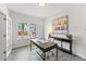Bright home office with a large window, desk, console table, and hardwood floors at 1047 House Finch Ave # Cc3-19-2P, Ravenel, SC 29470