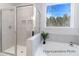 Bathroom featuring a glass-enclosed shower, soaking tub, and a large window at 1050 Marsh Harrier Dr # Cc3-15-3P, Ravenel, SC 29470