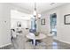 Open concept dining room adjacent to living room with modern chandelier at 1050 Marsh Harrier Dr # Cc3-15-3P, Ravenel, SC 29470