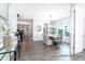 Bright dining area with wood floors, modern chandelier, and a view of the open-concept living spaces at 1050 Marsh Harrier Dr # Cc3-15-3P, Ravenel, SC 29470