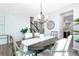 Elegant dining room with a statement chandelier, table setting, and views into other living spaces at 1050 Marsh Harrier Dr # Cc3-15-3P, Ravenel, SC 29470
