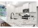 Stylish kitchen island with granite countertops, stainless steel appliances, and views to the backyard at 1050 Marsh Harrier Dr # Cc3-15-3P, Ravenel, SC 29470