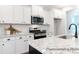 Bright kitchen features stainless steel appliances, white cabinets, and granite countertops at 1050 Marsh Harrier Dr # Cc3-15-3P, Ravenel, SC 29470