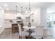 Open kitchen boasts white cabinets, stainless steel appliances, and adjacent dining area at 1050 Marsh Harrier Dr # Cc3-15-3P, Ravenel, SC 29470