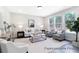 Bright living room with natural light, neutral furniture, and views of wooded area at 1050 Marsh Harrier Dr # Cc3-15-3P, Ravenel, SC 29470