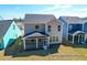 Rear exterior view of home with screened porch and ample yard space at 1050 Marsh Harrier Dr # Cc3-15-3P, Ravenel, SC 29470