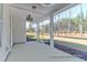 This screened porch features white paneled walls, ceiling fan, and views of the lush outdoors at 1050 Marsh Harrier Dr # Cc3-15-3P, Ravenel, SC 29470