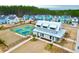 An aerial view of new construction homes with community tennis courts and manicured lawns at 1050 Marsh Harrier Dr # Cc3-15-3P, Ravenel, SC 29470