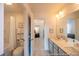 Well-lit bathroom with dual sinks, gray cabinetry, and a view into the bedroom at 1054 Marsh Harrier Dr # Cc3-15-5P, Ravenel, SC 29470
