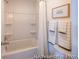 Bright bathroom featuring a shower-tub combo, white tiling, and decorative accents at 1054 Marsh Harrier Dr # Cc3-15-5P, Ravenel, SC 29470