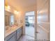 Bathroom with dual sinks, modern fixtures and vanity. Bedroom visible through open door at 1054 Marsh Harrier Dr # Cc3-15-5P, Ravenel, SC 29470