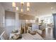 Elegant dining area with a modern chandelier, table set for a meal, and an open view into the kitchen at 1054 Marsh Harrier Dr # Cc3-15-5P, Ravenel, SC 29470