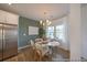Bright dining room with a stylish chandelier, modern table setting, stainless steel refrigerator, and ample natural light at 1054 Marsh Harrier Dr # Cc3-15-5P, Ravenel, SC 29470