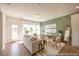 Comfortable living room featuring a plush sofa, stylish decor, and large windows offering abundant natural light at 1054 Marsh Harrier Dr # Cc3-15-5P, Ravenel, SC 29470